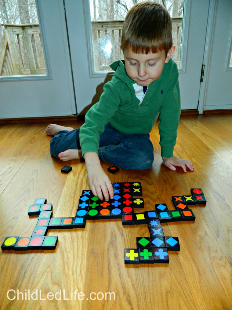 Must have game for your homeschool room! Qwirkle is fun for all ages. Preschoolers work on easy strategy and beginning game playing etiquette at ChildLedLife.com